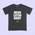 A dark charcoal gray t-shirt with bold white text reading 'REVOLUTIONARY' and smaller text below reading '19th', displayed flat against a light lavender background.