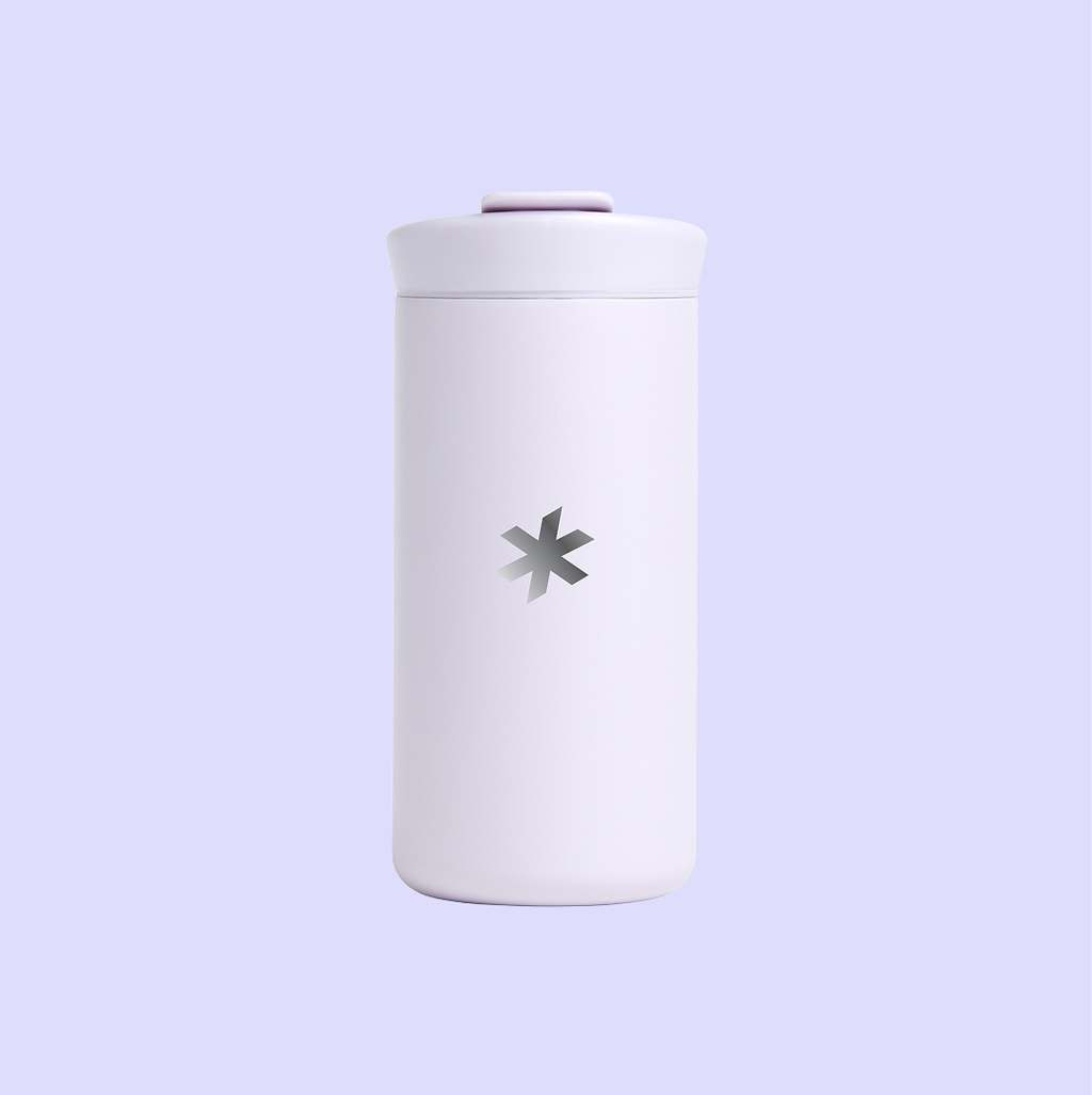 A lilac drinkware tumbler featuring The 19th's logo, an asterisk, engraved on the back.