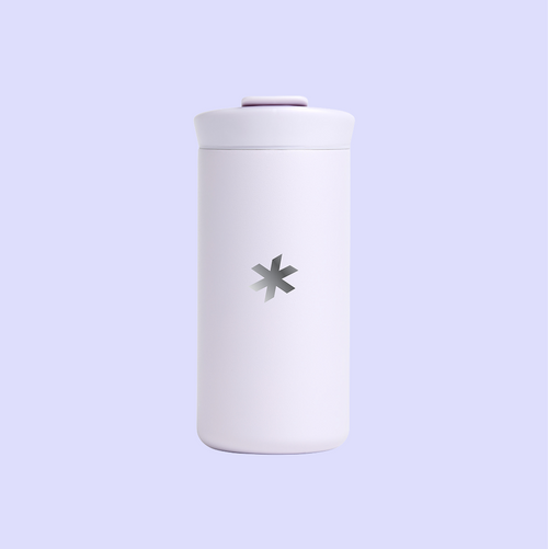 A lilac drinkware tumbler featuring The 19th's logo, an asterisk, engraved on the back.